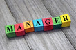 word manager on colorful wooden cubes