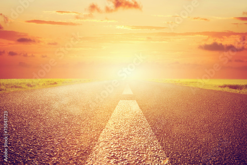 Fényképezés Long empty asphalt road towards sunset sun.