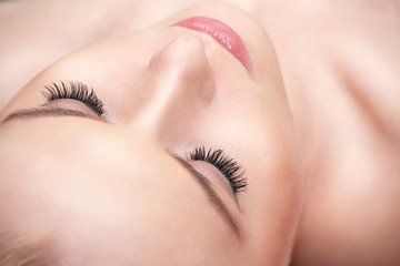 Lying woman eyes with long eyelashes.