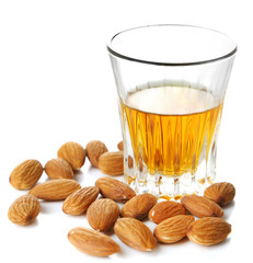 Dessert liqueur Amaretto with almond nuts, isolated on white