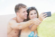 © william87 - Young Couple on Vacation Taking Selfie
