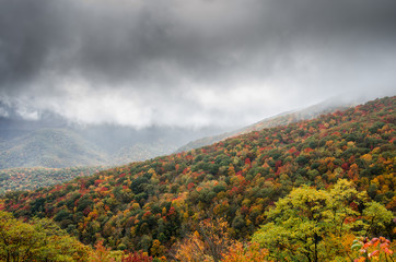fog rolls in over mountain slop in fall