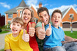 © grinny - Happy family near new house.