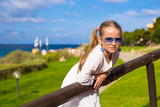 Fototapeta Uliczki - Adorable little girl during summer vacation outdoors