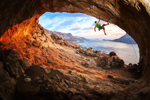 Young Man Lead Climbing In Cave Before Sunset