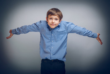 Wall Mural - teenager boy 10 years of European appearance spread his hands