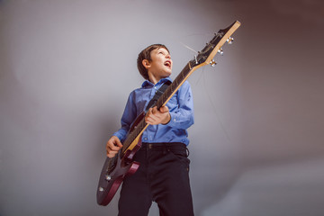 Wall Mural - boy adolescence European appearance sings plays guitar