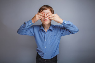 Wall Mural - boy teenager European appearance brown hair covers eyes with his