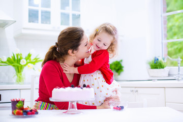 Mother and daughter baking strawberry pie