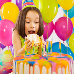 Wall Mural - Portrait of joyful little girl with cake at birthday party