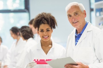 Wall Mural - lecturer and student smiling at camera in the lab