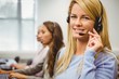 © WavebreakmediaMicro - Smiling call centre agent talking on the headset