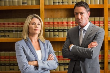 Wall Mural - Lawyers looking at camera in the law library