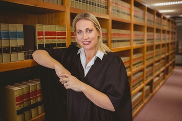 Poster - Smiling lawyer leaning on shelf