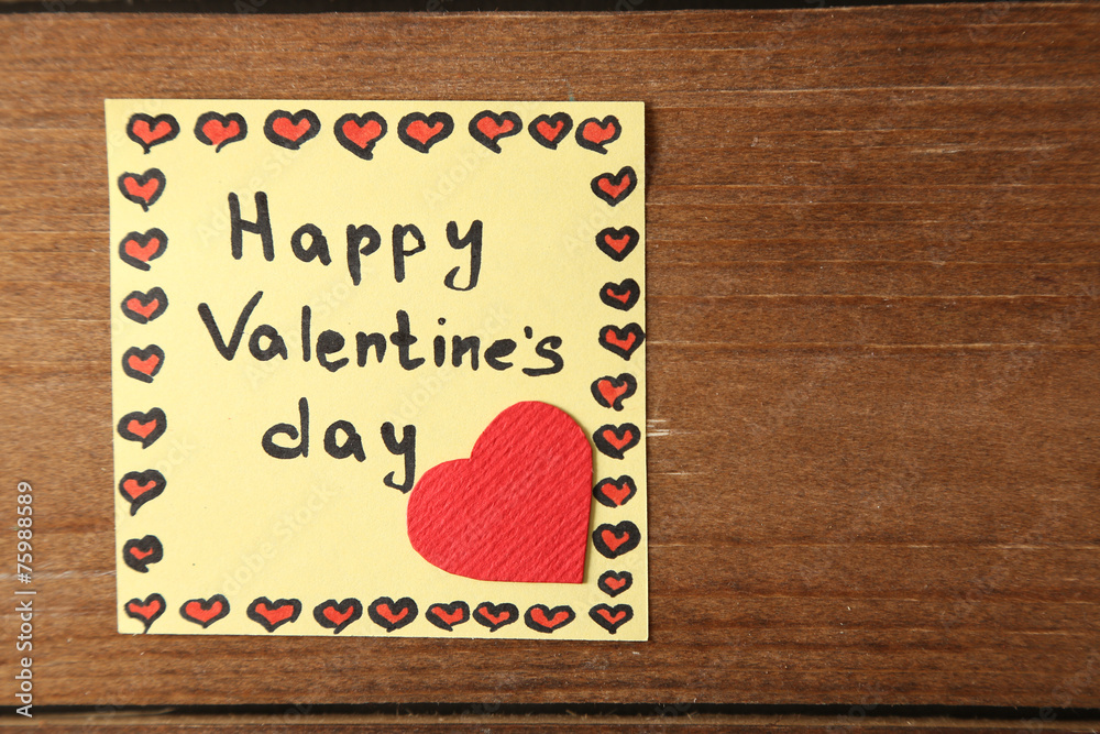 Valentines day note on wooden background