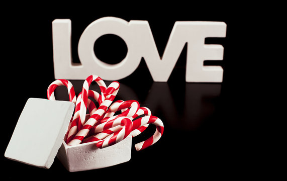 large letters LOVE and Heart Lollipop isolated on black - Stock