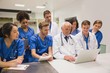 © WavebreakMediaMicro - Medical students and professor using laptop