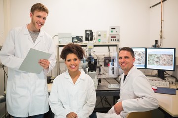 Wall Mural - biochemistry students using large microscope and computer