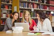 © WavebreakMediaMicro - Smiling mature student with classmates using laptop