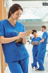 Wall Mural - medical student taking notes in hallway