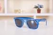 Blue sunglasses on table