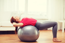 Smiling Redhead Girl Exercising With Fitness Ball