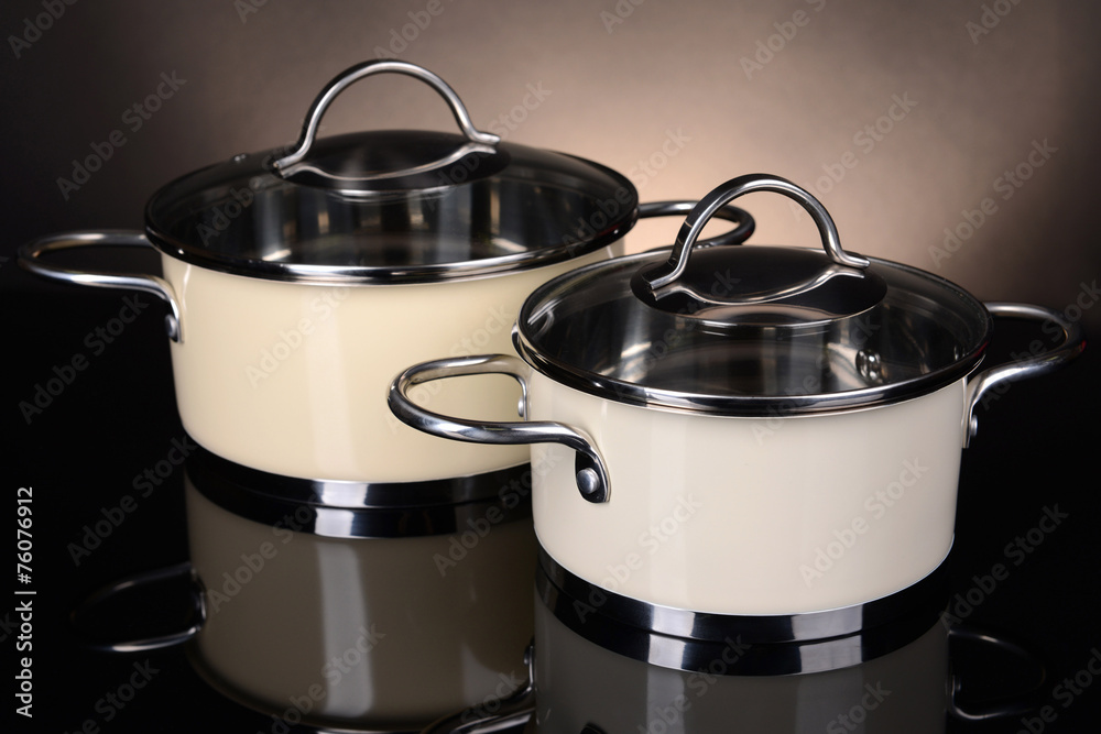 Pans on table on brown background