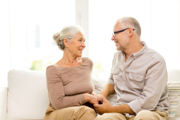 Wall Mural - happy senior couple hugging on sofa at home