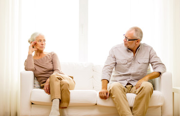 Poster - senior couple sitting on sofa at home