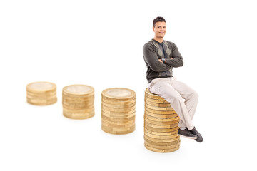 Wall Mural - Casual man sitting on a pile of coins