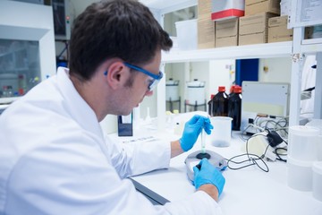 Close up of a chemist using a centrifuge