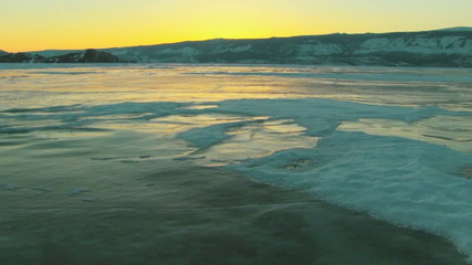 Wall Mural - Winter lake landscape at sunset