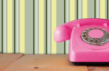 Wall Mural - Retro pastel mint telephone on wooden table and abstract retro g