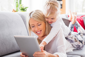 Mother and daughter using tablet computer