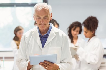 Wall Mural - science lecturer holding tablet pc in lab