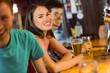 © WavebreakmediaMicro - Smiling friends talking and drinking beer