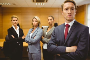 Serious lawyer standing with arms crossed