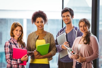 Poster - Four smiling classmates standing in front of the window