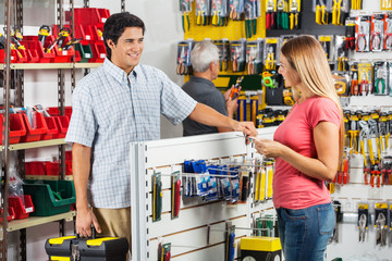 Wall Mural - Couple Choosing Tools In Hardware Store