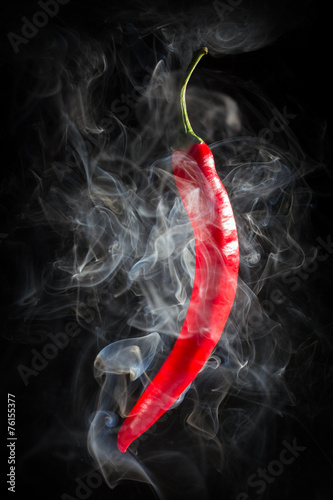 Plakat na zamówienie Smoking red hot chili Pepper on a black background