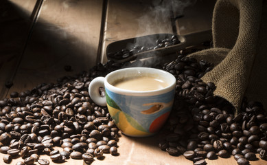 Wall Mural - cup of coffee on the wooden table