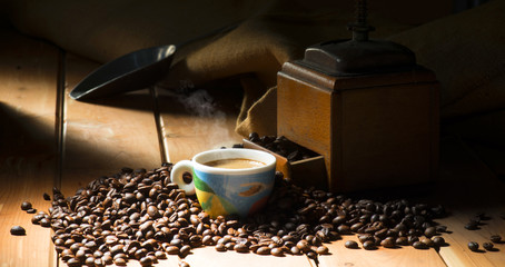 Wall Mural - cup of coffee on the wooden table