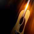 © BortN66 - acoustic guitar on a black background in the rays of light