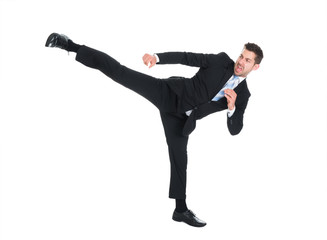 Businessman Kicking Over White Background