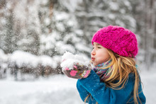 Cute Little Girl Blows Snow From Hands