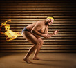 Very strange naked man farts by fire