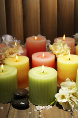 Poster - Beautiful candles with flowers on wooden background