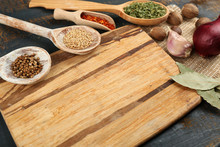 Different Spices And Herbs With Cutting Board