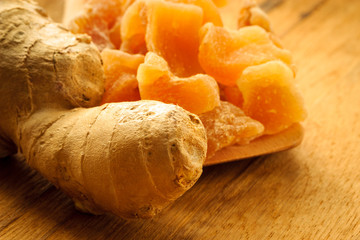 Wall Mural - Closeup root and candied ginger on wooden table