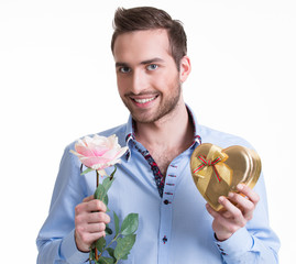 Wall Mural - Young happy man with a rose and a gift.